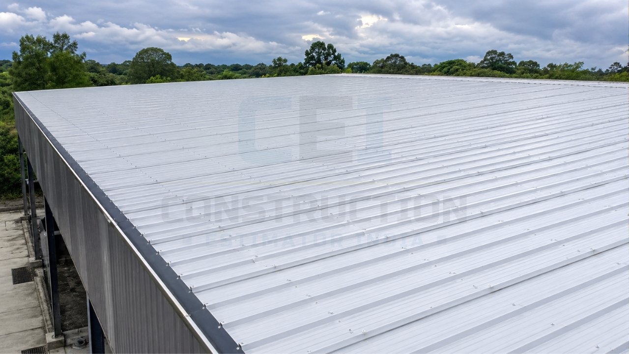 Industrial metal roofing system installed on a large warehouse building with corrugated steel roof panels.